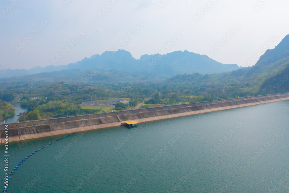 Aerial view of dam tower crane. Reservoir and sea water in recycle energy industry concept for electricity in Natural landscape background. Environment.