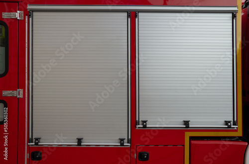 Fire engine roller shutters or roll-up doors. Fire brigade truck side view with the rollers down.