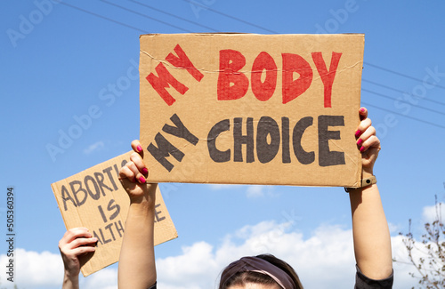 Protesters holding signs My Body My Choice and Abortion Is Healthcare. People with placards supporting abortion rights at protest rally demonstration. photo