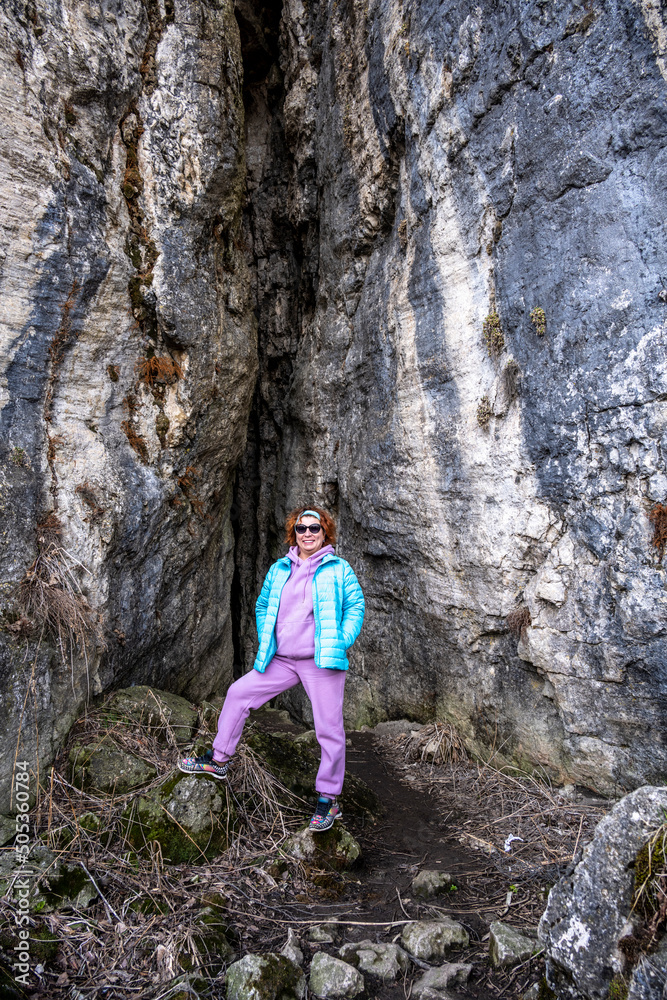 a woman tourist in a pink suit poses against the backdrop of beautiful mountains of gorges and stunning views of the Caucasus mountains
