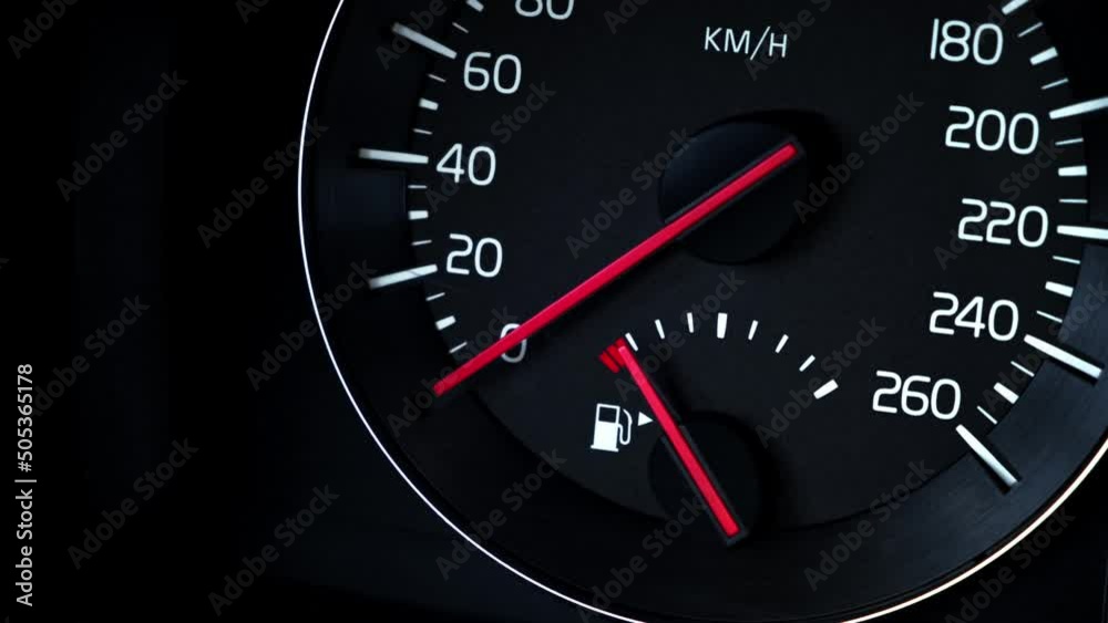 Close-up Instrument car panel with speedometer, low fuel level, ABS and other icons. Engine start and stop. Fuel crisis concept. High price for a diesel, gasoline, oil and natural resources. Red lit. Close-up Instrument car panel with speedometer, low fuel level, ABS and other icons. Engine start and stop. Fuel crisis concept. High price for a diesel, gasoline, oil and natural resources. Red lit.