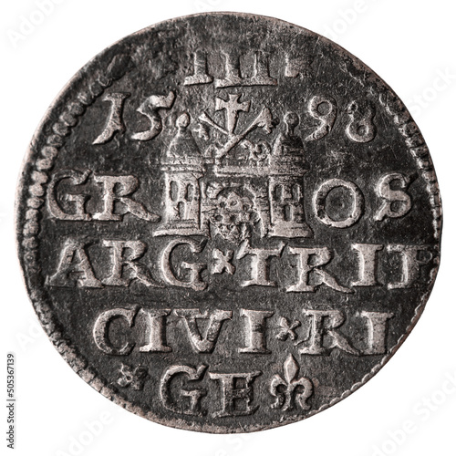 Obraz na płótnie Single old silver coin 16th century isolated on white background. Reverse of three groschen with Greater coat of arms of Riga. Closeup. w salonie