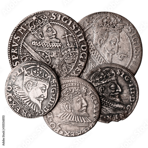 Old silver coins 16-17th century isolated on white background. Averse of ortsthaler and triple groschen with portrait of Sigismund III Vasa. Selective focus. photo