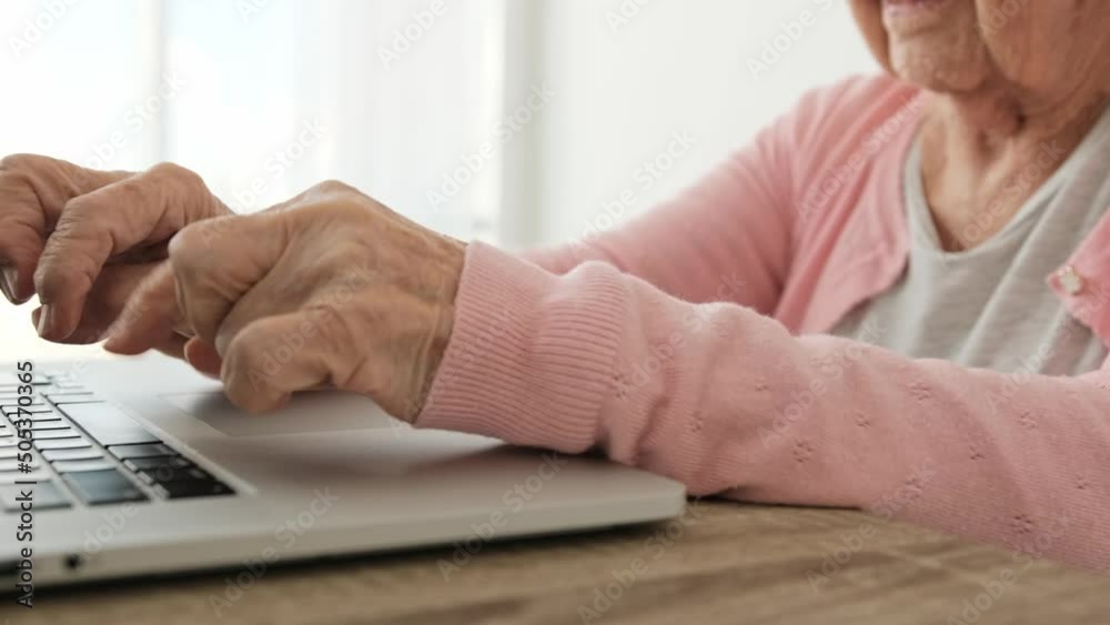 Senior woman hands typing on laptop keyboard at home. Elderly female person pushing notebook buttons slowly indoors