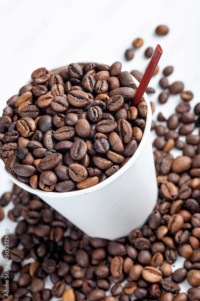 Fototapeta premium Close up view of a white plastic cup and coffee beans