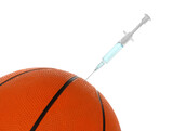Basketball ball with syringe sticking out on white background, closeup. Doping concept