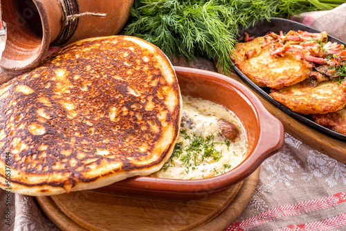 Thick pancake with sauce and sausages. Machanka