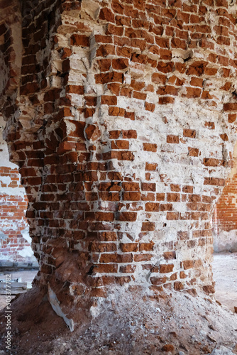 Antique red brick masonry. Ruined wall of an old Russian church.