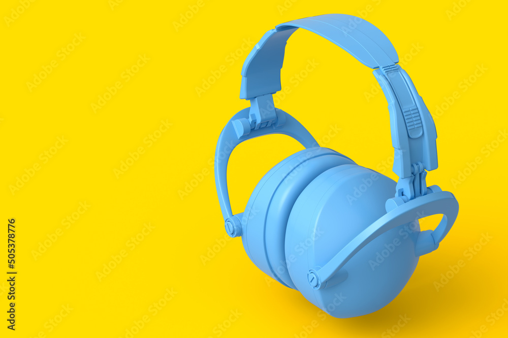 Protective earphones muffs isolated on a yellow monochrome background Protective earphones muffs isolated on a yellow monochrome background