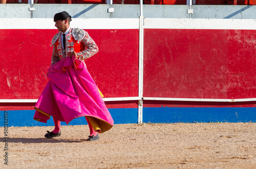 a Spanish bullfighter practices with his capote moments before the bullfight