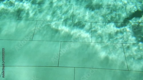 Shadow of a Person Swimming Underwater in Swimming Pool with Wave Formats in Switzerland. photo