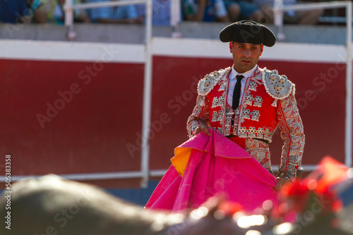 a Spanish bullfighter during his performance in the bullfight photo