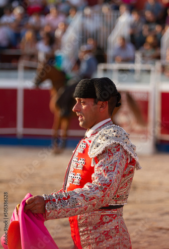close up of a concentrated bullfighter holds the capote in the bullfight