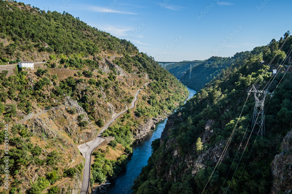 Canyon with rocks and vegetation and river Zêzere, aerial view on Cabril dam with bridge in the background, Pedrogão Grande PORTUGAL