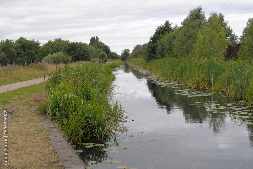View Along Old Rural Canal with Reflections in Still Water View Along Old Rural Canal with Reflections in Still Water