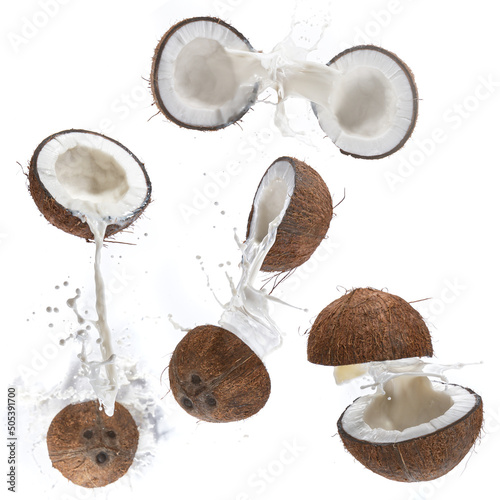 Cracked Coconut with milk splash flying in the air.