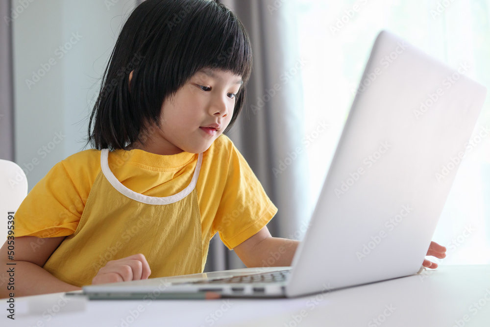 little asian girl student study online using laptop computer at home little asian girl student study online using laptop computer at home