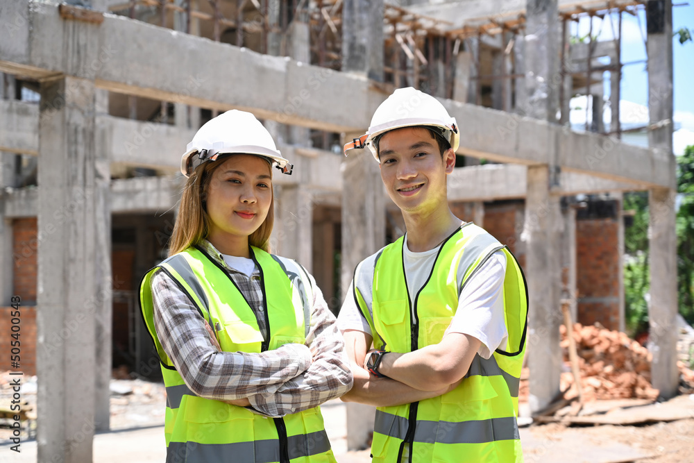 Two architect standing with arm crossed at building construction site. Two architect standing with arm crossed at building construction site.