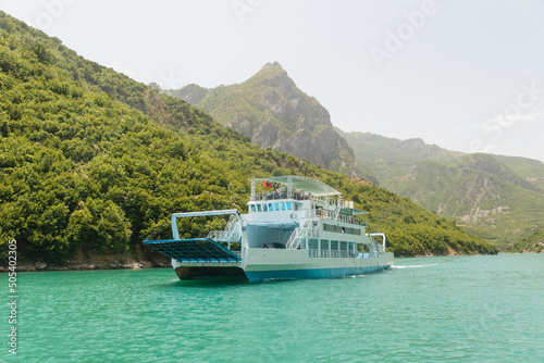 Fierza-Komani Ferry Stop in Komani Lake, Albania. Drin river, Albanian fjords with boat, ship, popular destination in Albania © Andrii Marushchynets