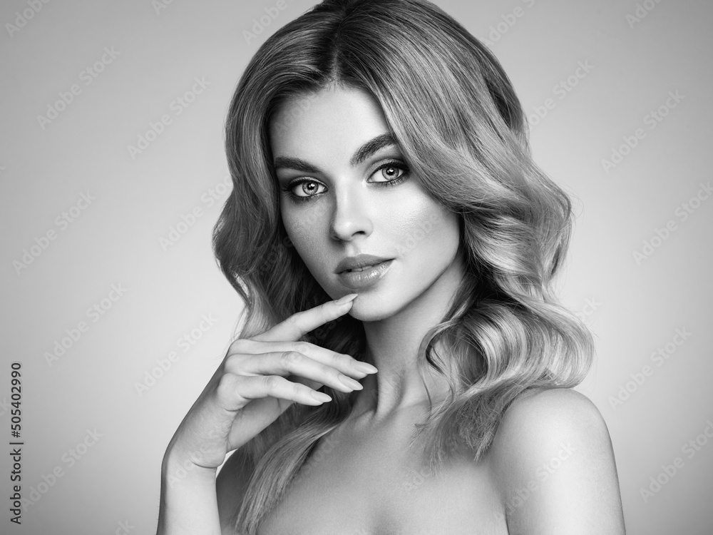 A beautiful young woman with shiny wavy blonde hair. Model with healthy skin, close up portrait. Cosmetology, beauty and spa. Fashionable black and white photography A beautiful young woman with shiny wavy blonde hair. Model with healthy skin, close up portrait. Cosmetology, beauty and spa. Fashionable black and white photography