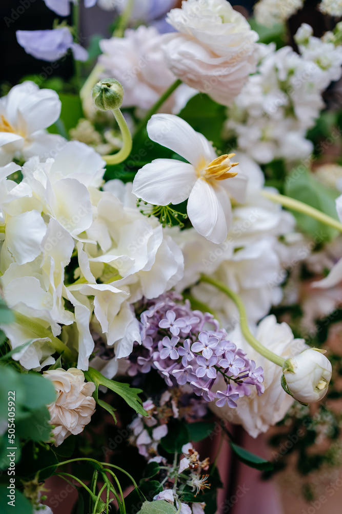 Fototapeta premium Banquet table is decorated with plates, cutlery, glasses and flower arrangements