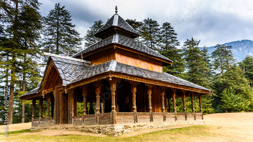 Shangchul mahadev temple in the meadow of Shahgarh, surrounded by Deodar Tree and Himalayas mountains in Sainj Valley, Great Himalayan National Park, Himachal Pradesh, India