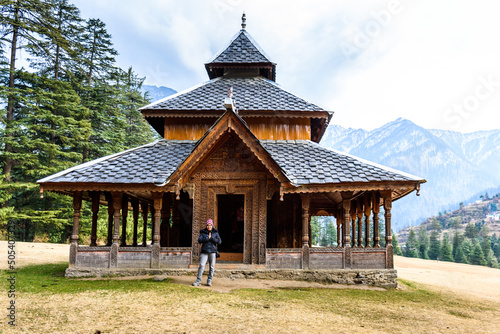 Young woman worshipping in Shangchul mahadev temple in the meadow of Shahgarh, surrounded by Deodar Tree and Himalayas mountains in Sainj Valley, Great Himalayan National Park, Himachal Pradesh, India © Sumit