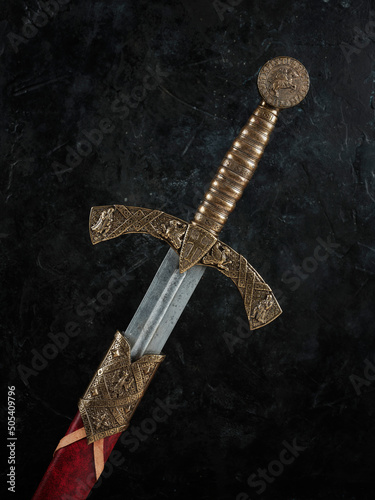 Closeup of a knightly medieval sword in a red scabbard