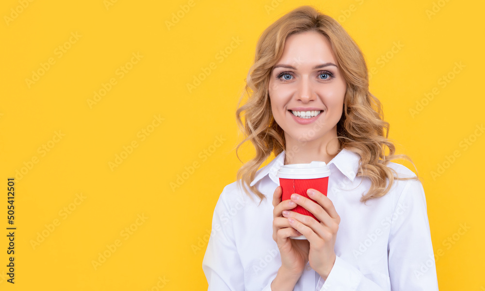 smiling blonde woman with morning coffee cup on yellow background