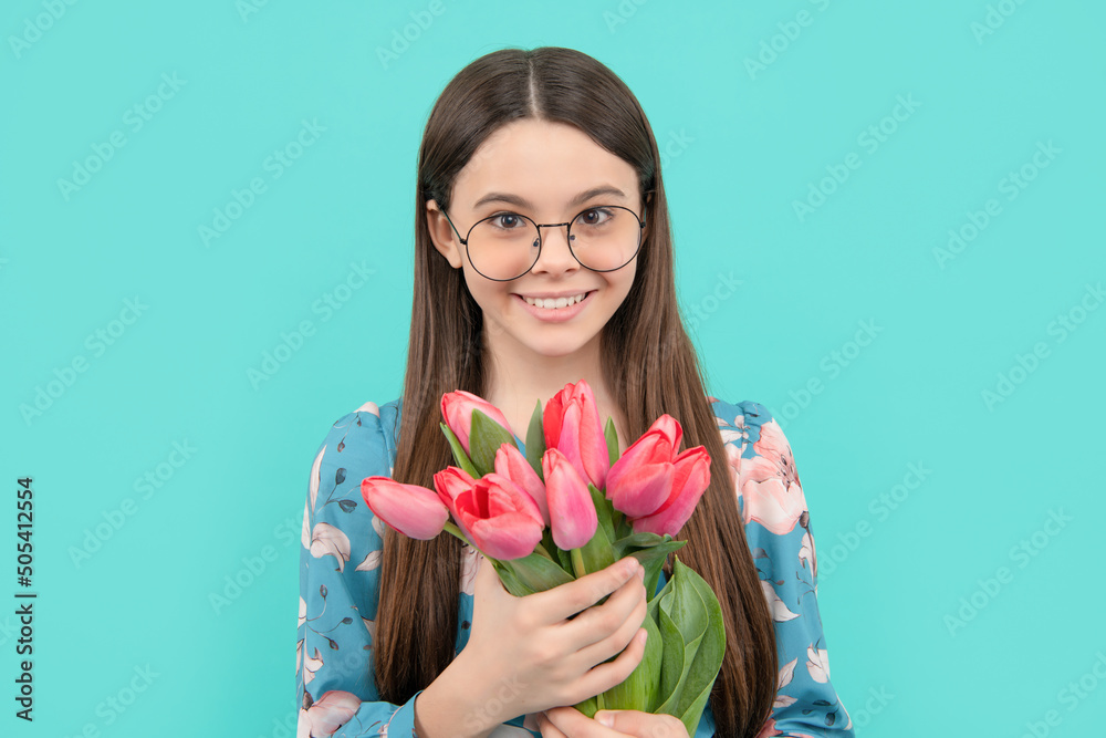 positive child in glasses with tulips. mothers or womens day. kid hold flowers for 8 of march. positive child in glasses with tulips. mothers or womens day. kid hold flowers for 8 of march.