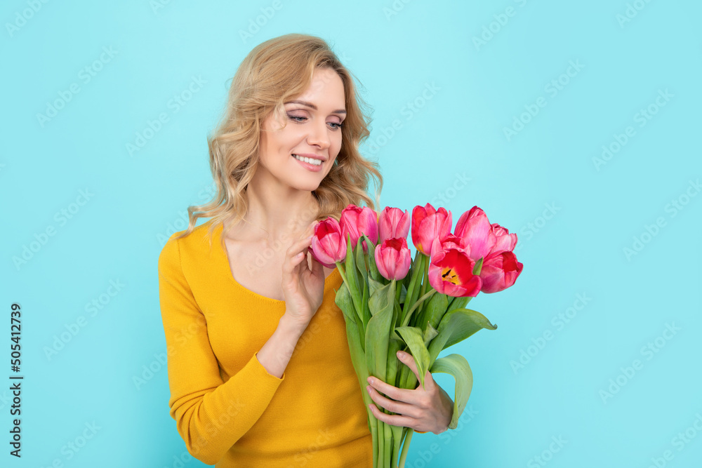 happy young woman with spring tulip on blue background happy young woman with spring tulip on blue background