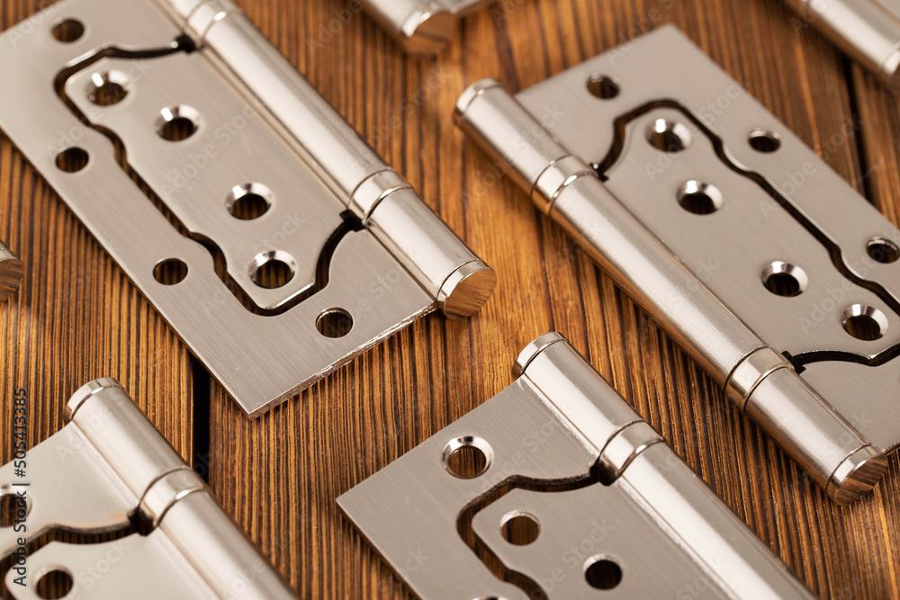 door metal hinges on a wooden background, macro. Door furniture door metal hinges on a wooden background, macro. Door furniture