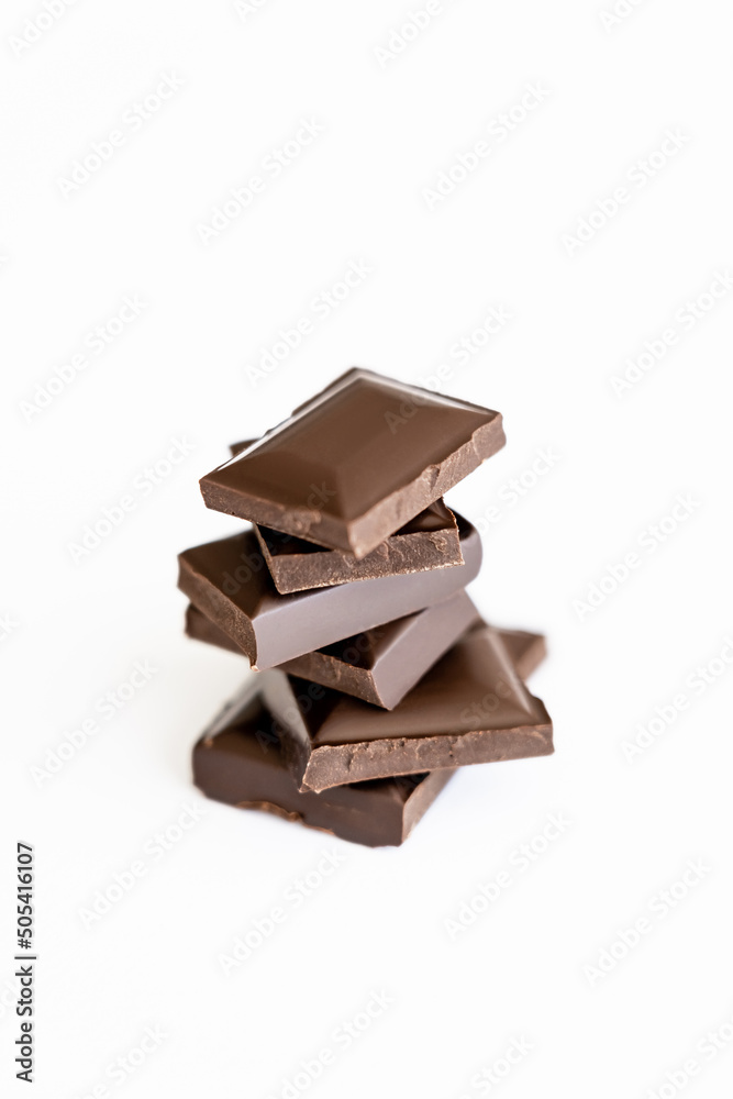 Close up view of milk chocolate pieces isolated on white. Close up view of milk chocolate pieces isolated on white.