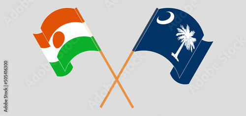 Crossed and waving flags of Niger and The State of South Carolina