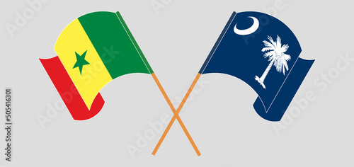 Crossed and waving flags of Senegal and The State of South Carolina