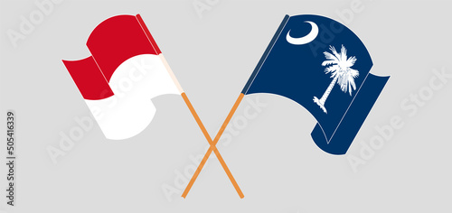 Crossed and waving flags of Monaco and The State of South Carolina