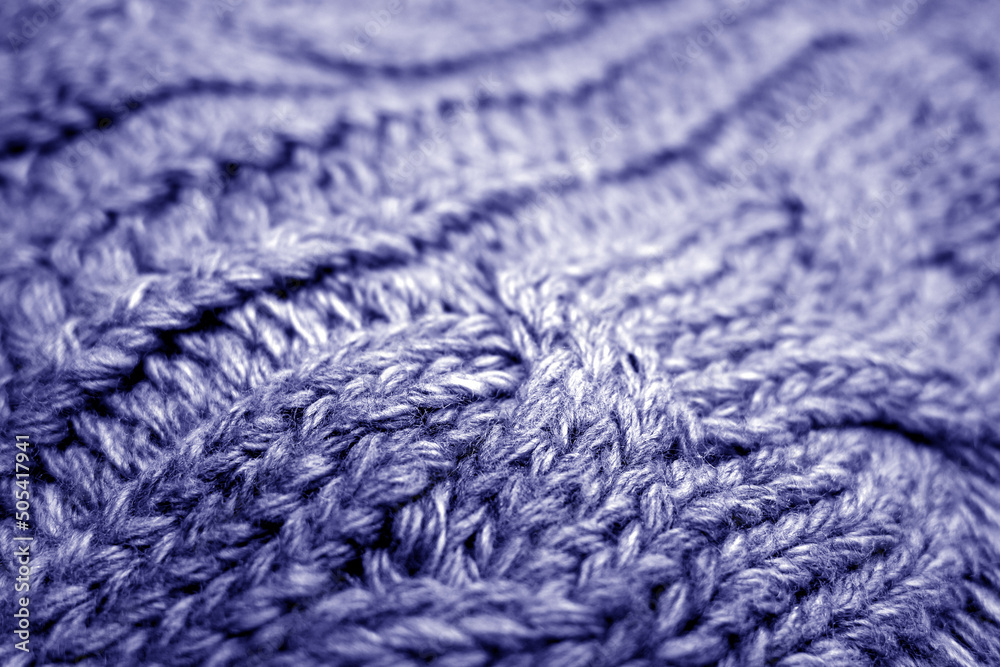 Warm knitting texture with blur effect in blue tone.