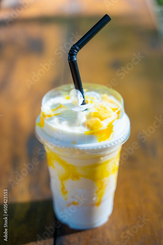 mango smoothie with yogert in plastic glass photo