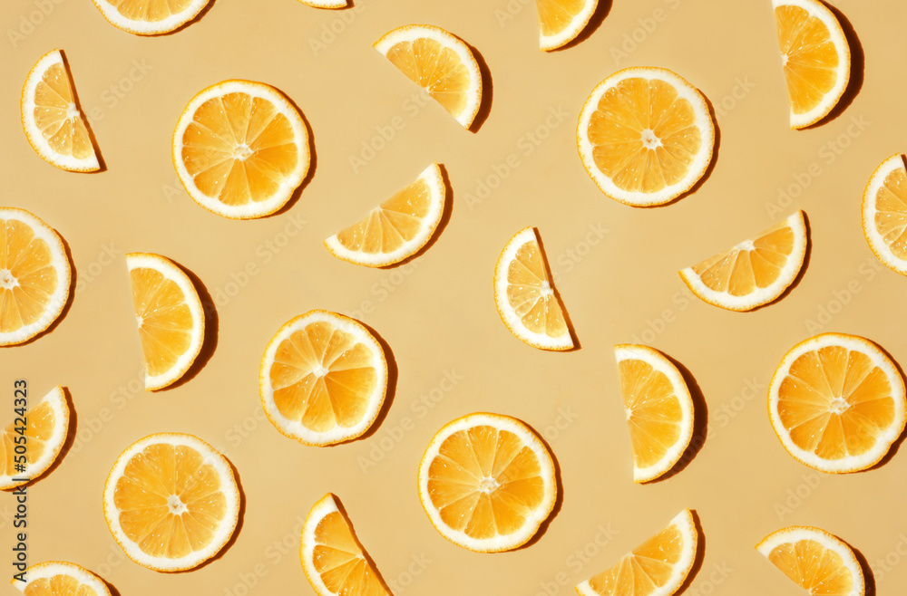 Pattern of many sliced lemons and oranges on a trendy bright yellow background. Flat lay, top view. Summer freshness, detox, antioxidants, healthy lifestyle concept