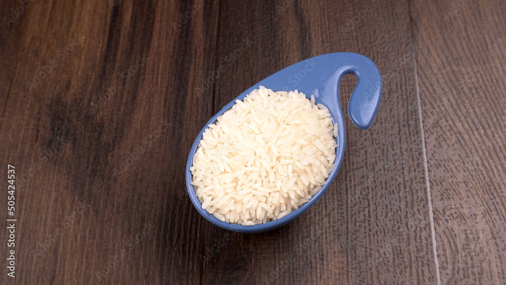 Uncooked dry rice in wooden bowl, Healthy food. Copy space. Uncooked dry rice in wooden bowl, Healthy food. Copy space.