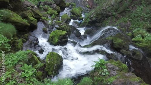 Small waterfalls in a stream in the forest photo