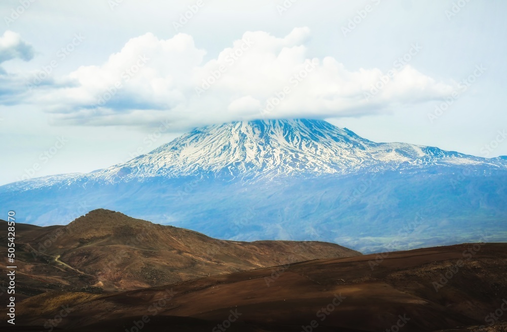 Landscape of snowy mountain ararat peak with cloud pass from Turkey side in spring. At the foot of mt Ararat