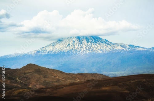 Landscape of snowy mountain ararat peak with cloud pass from Turkey side in spring. At the foot of mt Ararat