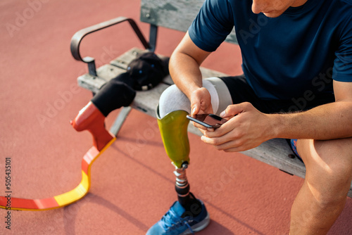 Disabled Young athlete using phone