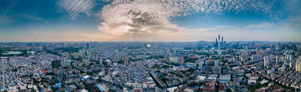 Panoramic shot of the buildings of a modern cityscape under cloudy sky