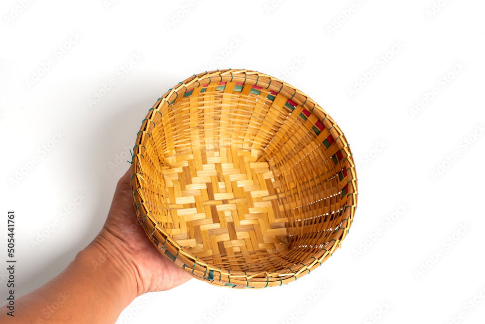 Fototapeta premium Hand holding Bamboo basket isolated on white background. 