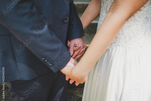 bride and groom holding hands © Wedding Nature Stock