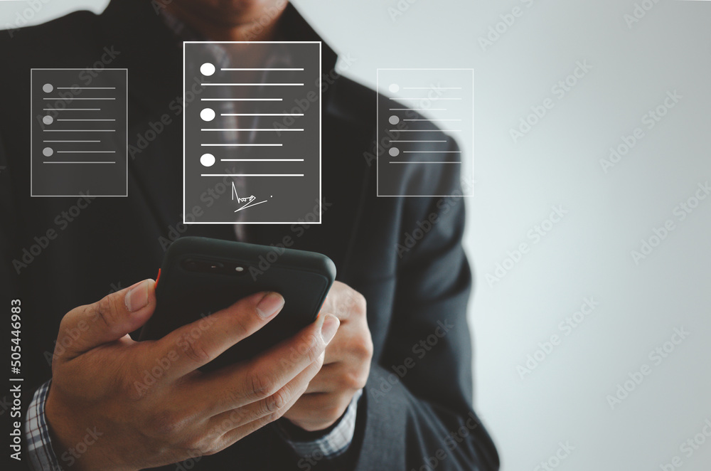 businessman holding smartphone business digital signing documents on virtual screen. businessman holding smartphone business digital signing documents on virtual screen.