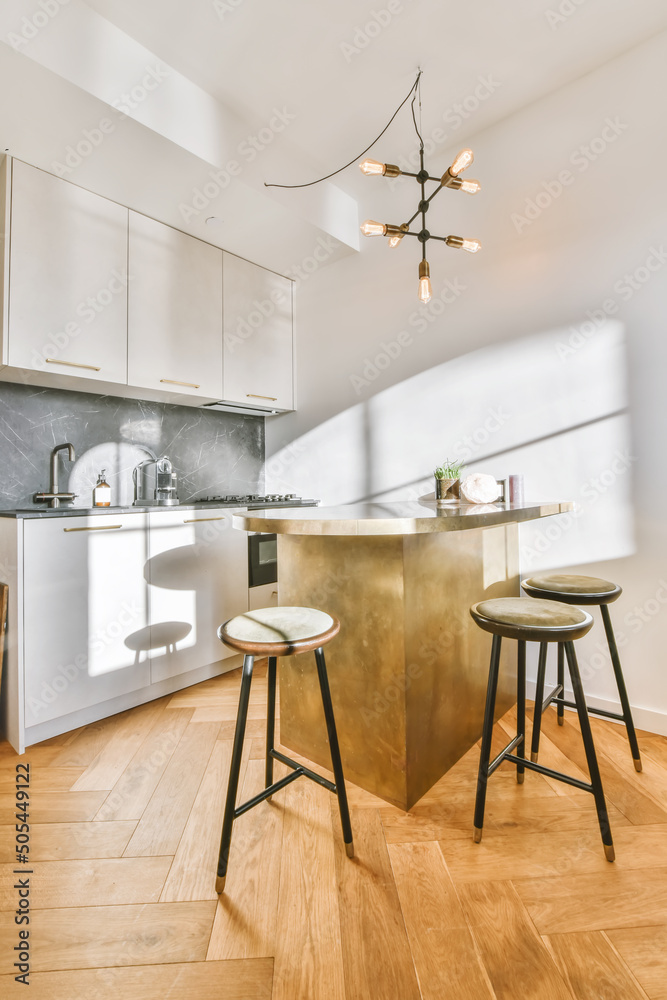 Interior of sunlit kitchen with modern furniture Interior of sunlit kitchen with modern furniture