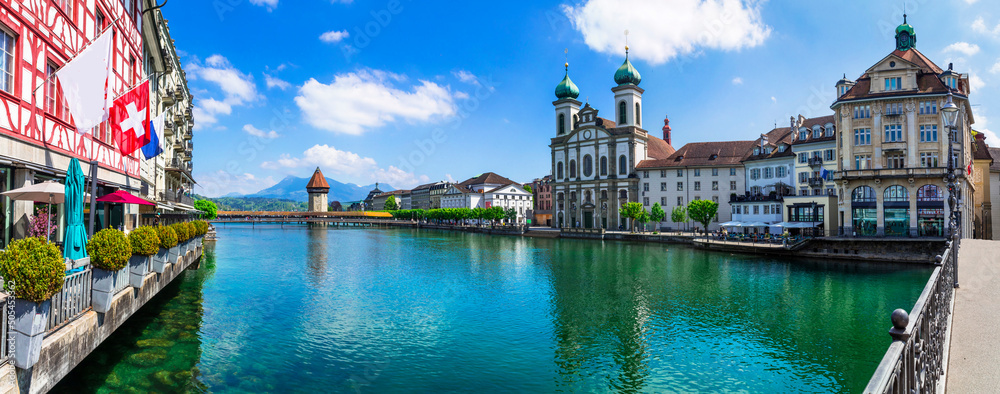 Panoramic view of Lucerne (Luzern) town with famous Chapel wooden bridge over Reuss river and Jesuit Church.  Switzerland travel and landmarks. - obrazy, fototapety, plakaty 